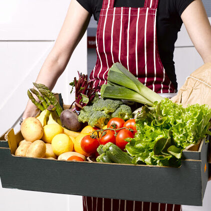 Woman delivering fruit and vegetable box